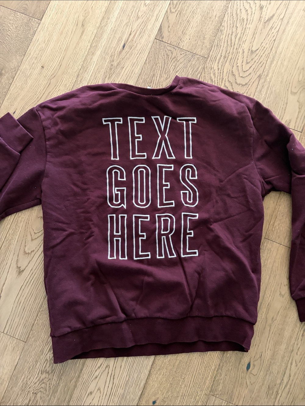 Divided Maroon Crewneck Sweatshirt with White Outline Back Text